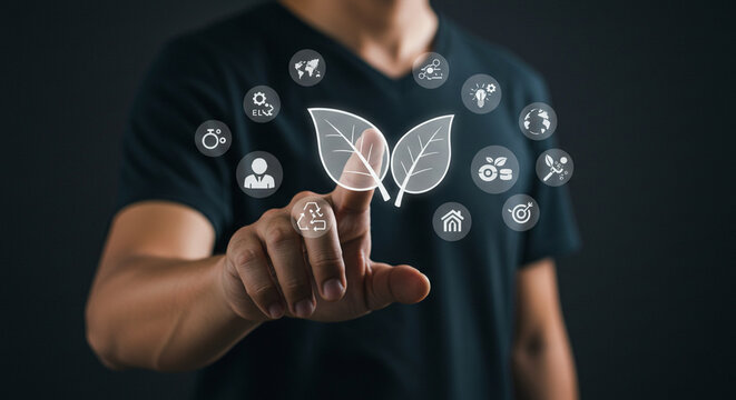 A person touching a leaf icon surrounded by other icons on a digital interface in a dark setting