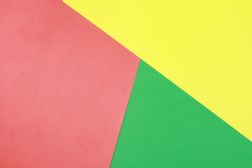Bold geometric background composed of intersecting red, yellow, and green paper sheets. The clean lines and bright solid colors create a playful and modern visual ideal for educational content