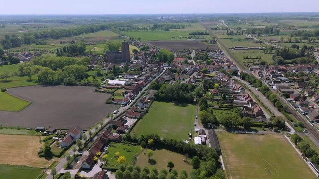 Approaching Lissewege from the Fields &ndash; High Drone Push-In by FlyLens