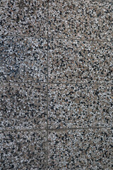 Macro view of an old gray concrete wall with surface pitting, erosion marks, and fine cracks. The weathered cement texture is dry and uneven, suitable for architectural visualization, brutalist