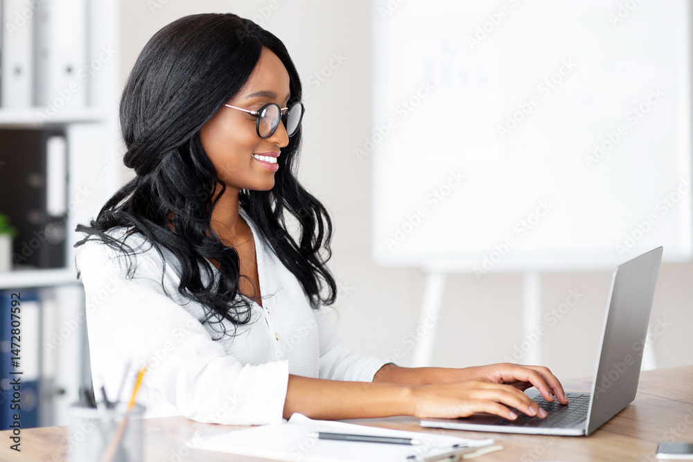 Poster happy female office worker using laptop computer and typing on keyboard at workplace. young black ma