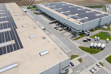 Fototapeta na wymiar Logistics centers with solar panels on roofs. Aerial view