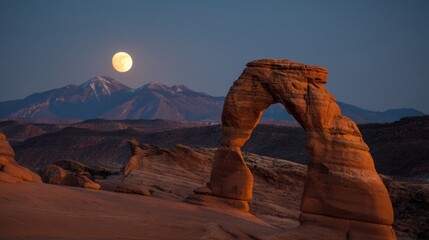 Glowing full moon by natural arch rock under twilight sky in desert canyon