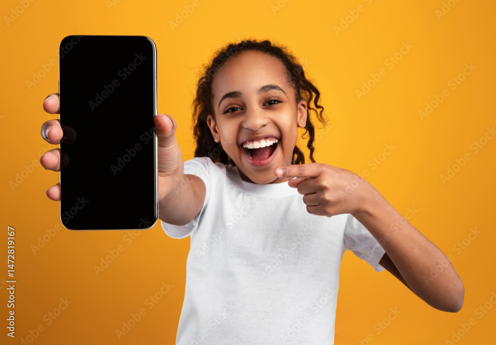 Poster excited black girl pointing at phone blank screen showing smartphone to camera recommending applicat