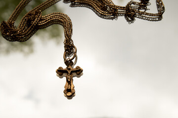Jewelry rosary lying on glass with natural white background, symbol of religion, horizontal photo...