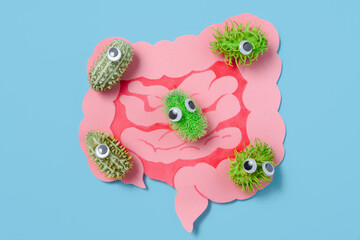 Googly-Eyed Microbes Gather Around Cutout Intestines