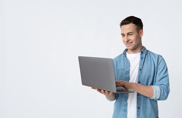 Smiling man working with laptop isolated on white background