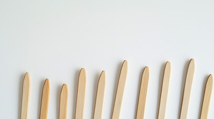 Fototapeta premium Wooden craft sticks on white background minimalist design simple natural light brown color palette