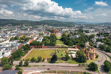 Summer skyline cityscape of Trier, Rhineland-Palatinate, Moselle, Germany. Aerial view of Kaiserthermen historical site and Kurfürstliches Palais with park in the background.