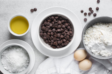 overhead view of mise en place for homemade chocolate chip cookies, ingredients for making chocolate chip cookies on a marble countertop