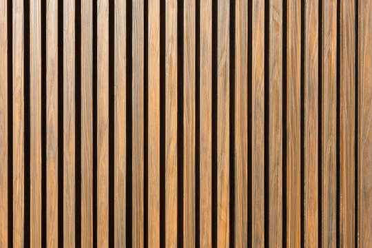 The wall is made of metal siding with imitation wooden slats