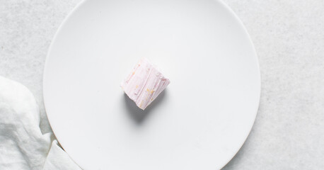 Overhead view of Nigerian Balewa candy, top view of hausa alewa candy on a white background, pulled hard sugar candy on a white countertop