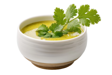 PNG Fresh cilantro garnished creamy green soup in a white bowl