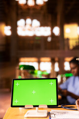 Black medical scholar reviewing case files in the library next to chroma key screen, preparing for a lecture or study session on medical practices. Med school pupil learns for a career. Close up.