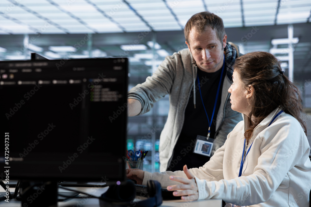 Poster it engineers in server farm brainstorming ways to repair equipment storing datasets. colleagues at w