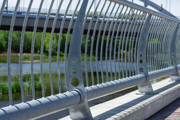 A sturdy metal railing is bolted to a concrete base.