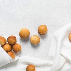 top view of homemade doughnut holes on a white background, process of making doughnuts