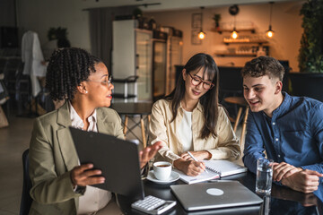 female financial adviser show finance plan to young entrepreneurs