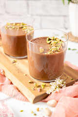Two chocolate mousses with pistachios on a board