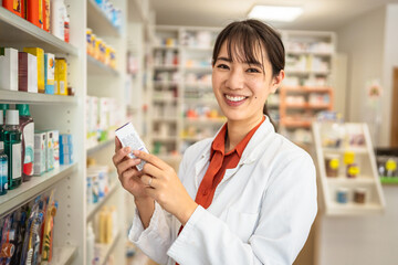Adult japanese female pharmacist arranges inventory, check medicine