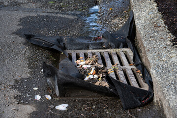Cloth barrier in storm drain grate to prevent debris runoff from construction site up the street...