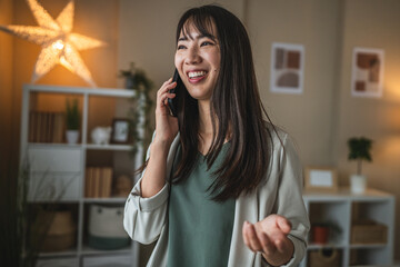 adult japanese woman talk on mobile phone in the living room