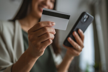 japanese woman use credit card and cellphone for shopping