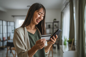 japanese woman use credit card and cellphone for shopping