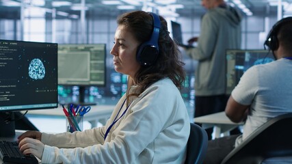 Developer listening music while programming in AI data center used for machine learning training....