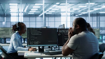 Sick IT professional in server hub sneezing while shielding data from potential threats using PC. Ill employee suffering from flu safeguarding data center against unauthorized access, camera A