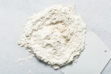 Overhead view of steamed bun dough being mixed on a granite countertop, top view of mantou dough being mixed