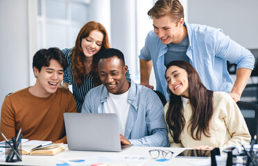Communication, Technology, Lifestyle And People Concept. Group of diverse international students or employees using laptop computers, studying and working, watching educational video, having fun