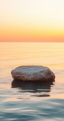Tranquil sunrise over calm water, featuring a solitary icy rock