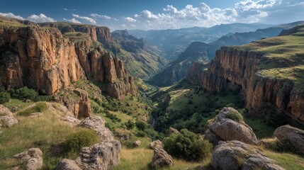 Obraz premium A breathtaking view of Ayhaft Canyon from a cliff edge, showcasing lush greenery and natural beauty.