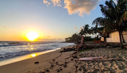 Fototapeta premium Beach sunset scene with golden sunlight reflecting off the water and shoreline