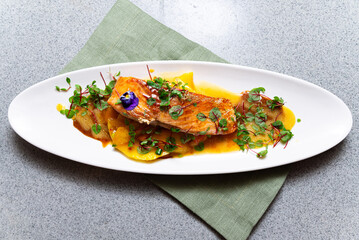 Plated gourmet salmon with mango sauce.