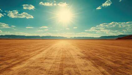 Desert road under a vibrant sky.  Sunlight blazes on a flat expanse of dry, golden earth.  A track winds into the distance
