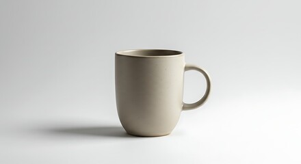 Fototapeta premium A stylish ceramic mug is perfectly set against a pristine, minimalist white backdrop for the design.