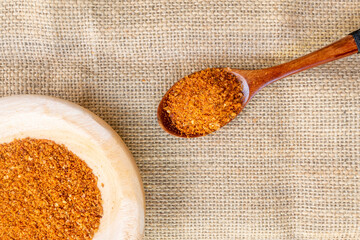 red lentils in a wooden spoon on burlap