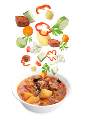 Delicious cooked stew. Fresh ingredients falling into bowl on white background
