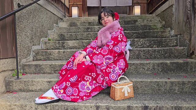 A pretty girl in a kimono. Kimono is the traditional dress worn popular in Japan. American girl posing in kimono outdoors. 