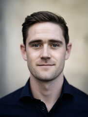 Fototapeta premium Male Model Portrait Close-up Confident Professional Expression Young Handsome Business Casual Identity Isolated Clean Grooming Facial Features Soft Focus Light Background Lifestyle Personality 