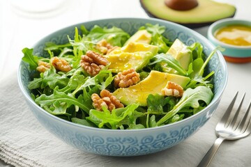 Fresh, healthy salad with avocado, walnuts, and greens
