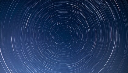 Stunning circular star trails against a deep blue night sky. Perfect for backgrounds, websites, or artistic projects.