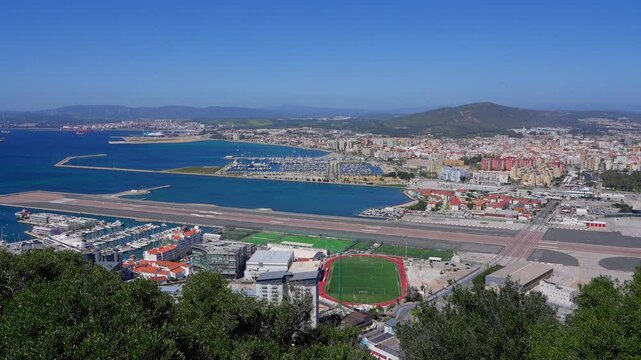 Boats resting in Alcaidesa Marina with city of La Linea de la Concepcion in the background