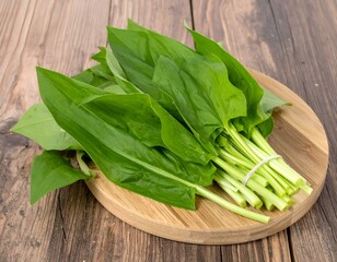 Fresh bunch of green plantain leaves on a wooden board.  Perfect for culinary, herbal, or health-related projects.