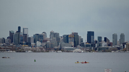Kayakers paddling on Lake Union with the Seattle skyline in the background