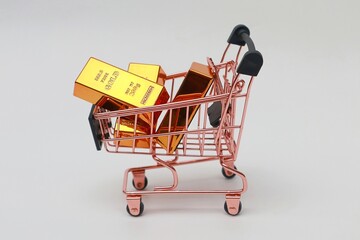 Pile of gold bars in a shopping cart
