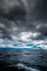 The dark sky with heavy clouds converging and a violent storm before the rain.Bad or moody weather...