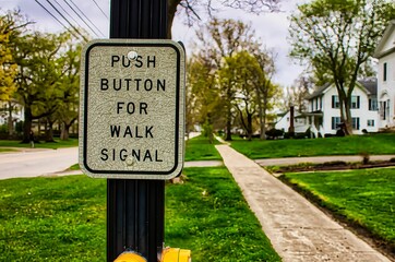 Instruction sign for walk signal at intersection crosswalk